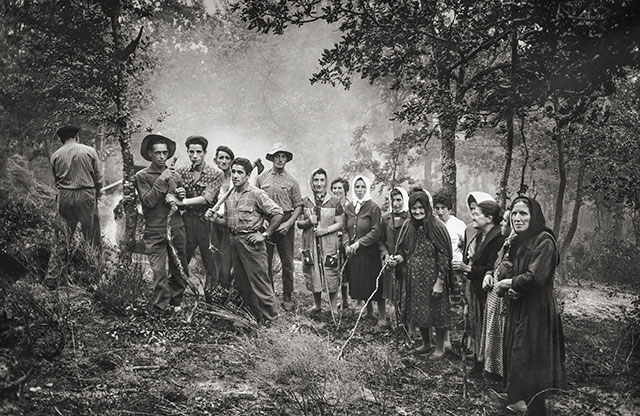 Un grupo hace una pausa entre los árboles. Las herramientas siguen en las manos; cada persona se coloca y mira de una manera distinta.